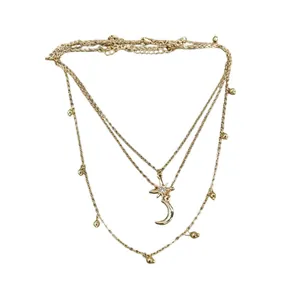 Elegant three-layer gold necklace featuring a sparkling rhinestone star and crescent moon