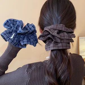 Detailed view of Korean style plaid fabric double-layer hair scrunchies on model