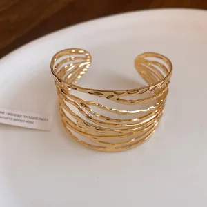 Close-up of the vintage twisted gold feather open cuff bracelet texture.
