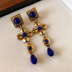 Elegant vintage palace style drop earrings featuring gold flowers and blue lapis stones
