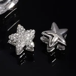 Elegant pair of silver-tone star-shaped ear cuffs featuring sparkling zirconia pavé stones