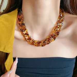 Detailed view of a retro chunky amber acrylic chain necklace with leopard print pattern