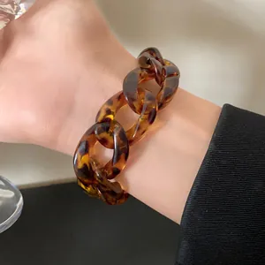 High-quality close-up detail of a retro leopard print acrylic chunky chain bracelet on a wrist