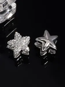 Close-up of silver star ear cuffs with sparkling zirconia and polished finish