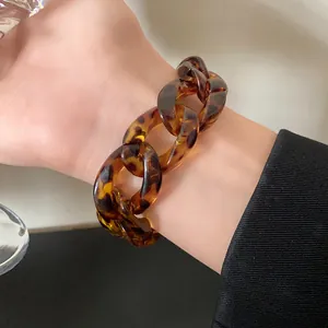 Close-up of a stylish leopard print acrylic chain bracelet with vintage amber texture