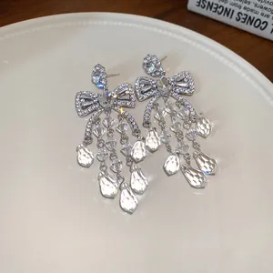 Sparkling silver bow chandelier earrings with crystal teardrop tassels