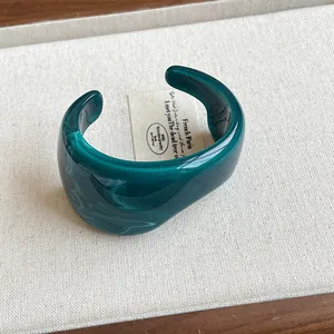 Detail shot of a vintage emerald green marbled resin irregular open cuff bracelet