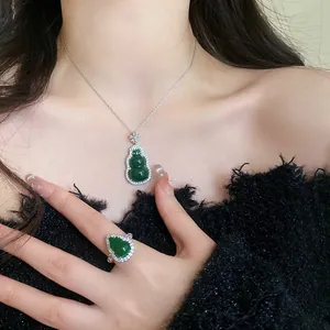 Elegant detail of a green resin gourd necklace and ring set adorned with zircon crystals