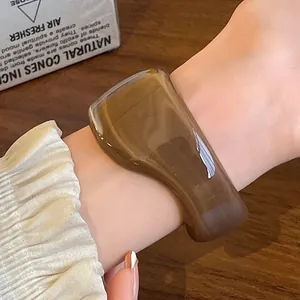 Close-up of vintage irregular smudge pattern resin open cuff bracelet worn on wrist
