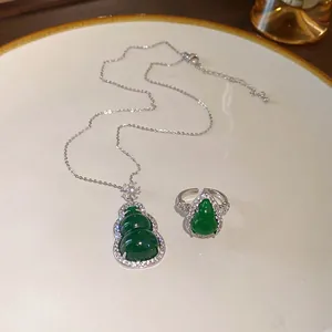 Detailed macro view of a green resin gourd necklace and ring set with sparkling zircon borders