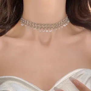 Close-up of an elegant silver zircon rhinestone choker necklace on a model's neck.