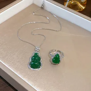 Detailed view of a green resin gourd pendant necklace and matching zircon ring set