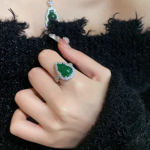 Detailed view of an elegant green resin gourd ring and necklace set with zircon pavé