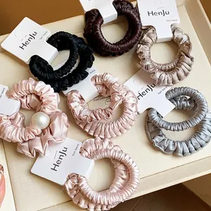 Collection of elegant satin pleated scrunchies with pearl accents in neutral colors