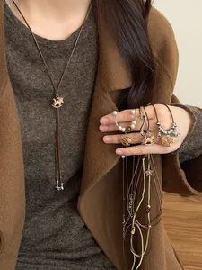 Detailed view of Maillard style wooden rocking horse double-layer sweater necklace
