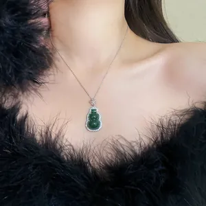 Close-up of a vintage Chinese style green gourd pendant necklace worn on model
