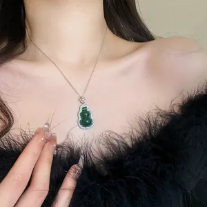Close-up of elegant New Chinese style necklace with a green resin gourd pendant.