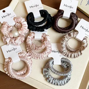 Collection of elegant pleated satin hair scrunchies in various neutral and metallic colors