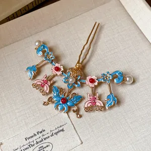Macro detail of a traditional Chinese hair pin featuring butterfly floral motifs and pearls.