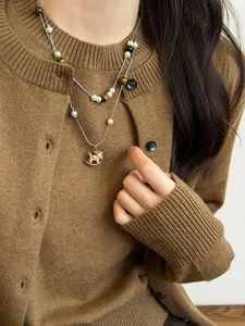 Close-up of vintage Maillard double-layer necklace with wooden rocking horse pendant