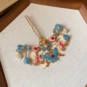 Detail of a Chinese style butterfly and flower hair fork with pearls and gold finish