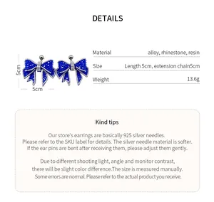 Close-up of sparkling blue rhinestone bow earrings with detailed material specifications.