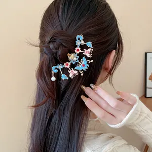 Close-up detail of a Chinese style butterfly hair pin with pearls on a bun