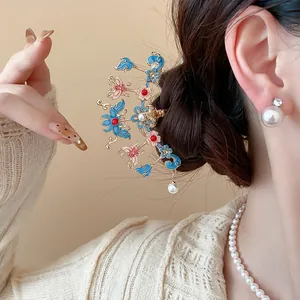Close-up of elegant Chinese style butterfly flower hair stick with pearl in a bun