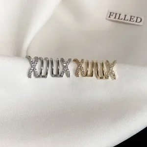 Detailed view of intertwined zirconia ear bone clips in gold and silver finish.
