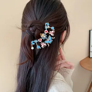 Detailed view of traditional Chinese style hair clip with butterfly and pearl motifs