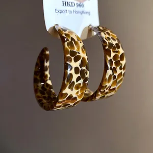 Elegant vintage leopard print acetate C-shaped hoop earrings with a smooth glossy finish