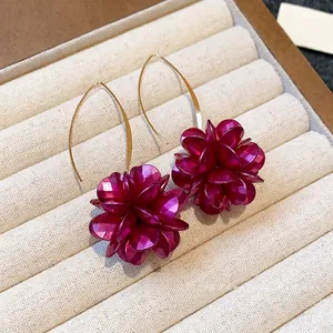Elegant vintage-style earrings with magenta floral charms on long gold hooks