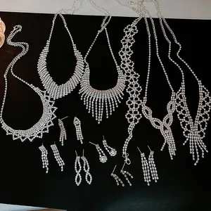 Close-up of elegant silver rhinestone jewelry sets featuring various necklace and earring designs.