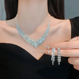 Close-up of elegant rhinestone fringe necklace and earring set for evening wear.