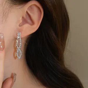 Elegant silver-tone rhinestone drop earrings shown on model for formal evening wear
