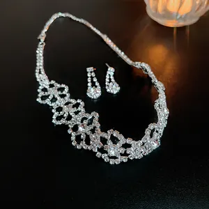 Elegant silver rhinestone jewelry set featuring a floral necklace and drop earrings.
