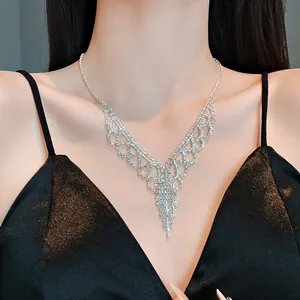 Detail of sparkling rhinestone fringe necklace on model wearing black dress