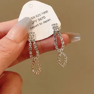 Elegant rhinestone infinity drop earrings displayed on a white product card for evening wear.