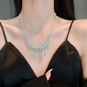 Close-up of a sparkling silver rhinestone tassel necklace on a model for evening wear