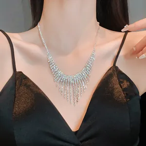Detailed macro view of an elegant sparkling rhinestone tassel fringe necklace on a model