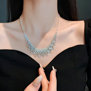 Close-up of elegant silver fringe necklace with sparkling rhinestones worn by a model.