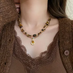 Detail view of a vintage Maillard-style layered necklace featuring irregular tiger eye stones