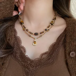 Close-up of a double-layered tiger eye necklace featuring chic Maillard style aesthetics.