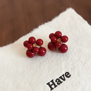 Elegant red fireworks cluster stud earrings with gold accents for New Year celebration