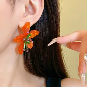 Handmade vibrant orange crystal flower stud earrings with translucent resin petals for women