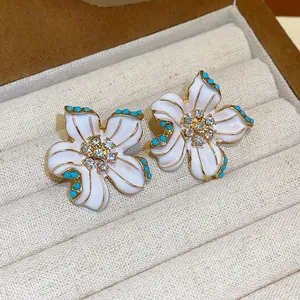 Vintage style white enamel flower stud earrings with turquoise beads and rhinestones