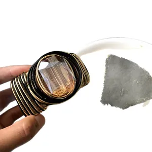 Handmade woven gold and black wire cuff bracelet with large smoky glass gemstone
