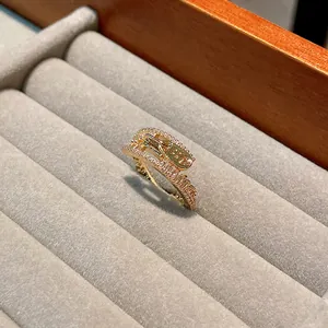 Close-up of a gold-plated zipper ring with pavé zircon stones in a velvet tray