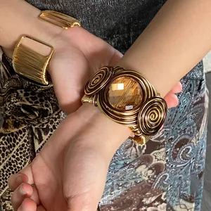 Detail of a luxury wire-wrapped cuff bracelet with large amber glass gemstone
