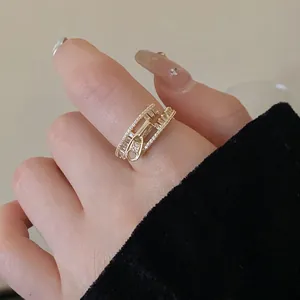 Close-up of a gold-plated open ring featuring a unique zirconia-encrusted zipper design.